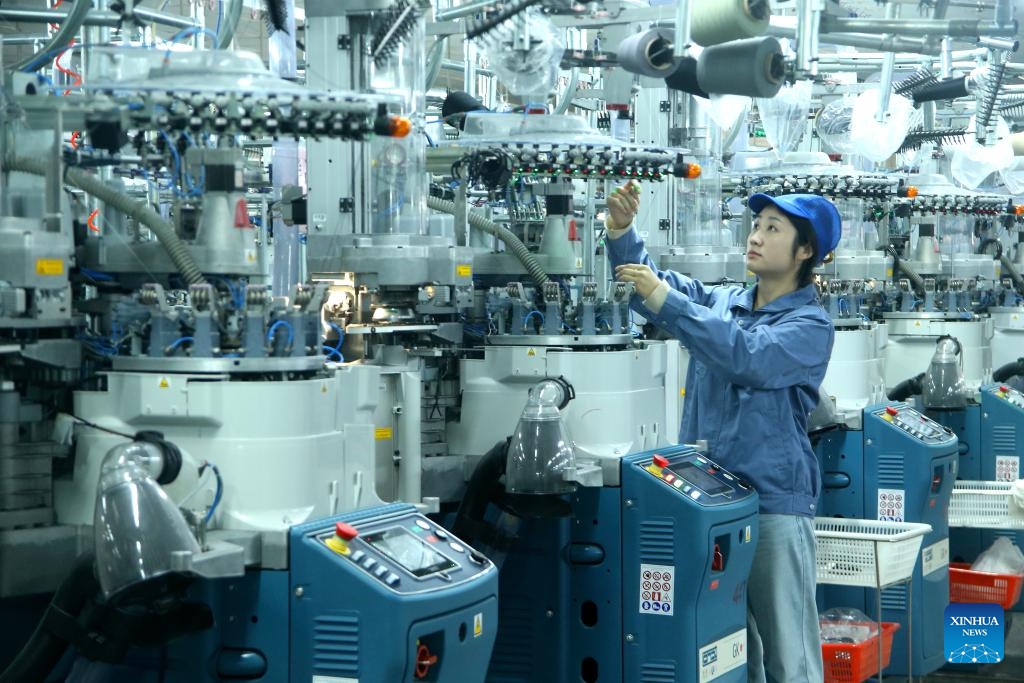 A worker works on a production line of a sock company in Qingdao, east China's Shandong Province, on March 16, 2026. (Photo: Xinhua)