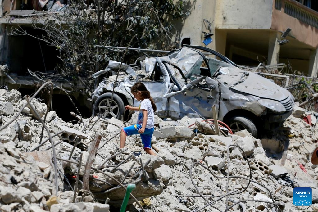 This photo taken on June 15, 2026 shows a girl inspecting destroyed buildings in Deir Qanoun En Nahr, south Lebanon. Lebanon's Public Health Emergency Operations Center said the cumulative toll from Israeli attacks since March 2, 2024, has reached 3,798 killed and 11,781 wounded as of June 15, 2026. (Photo: Xinhua)