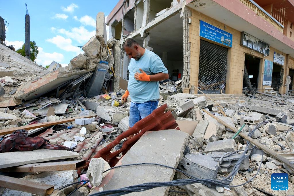 This photo taken on June 15, 2026 shows a man inspecting destroyed buildings in Deir Qanoun En Nahr, south Lebanon. Lebanon's Public Health Emergency Operations Center said the cumulative toll from Israeli attacks since March 2, 2024, has reached 3,798 killed and 11,781 wounded as of June 15, 2026. (Photo: Xinhua)