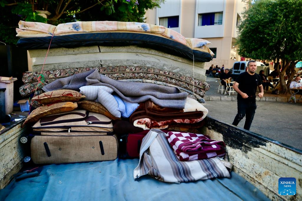This photo taken on June 15, 2026 shows displaced people collecting their luggage in preparation for returning to their villages in Sidon, southern Lebanon. Despite their different experiences, displaced residents interviewed by Xinhua shared a common belief that returning home depends not only on ending the fighting but also on rebuilding damaged communities and restoring basic services. (Photo by Ali Hashisho/Xinhua)