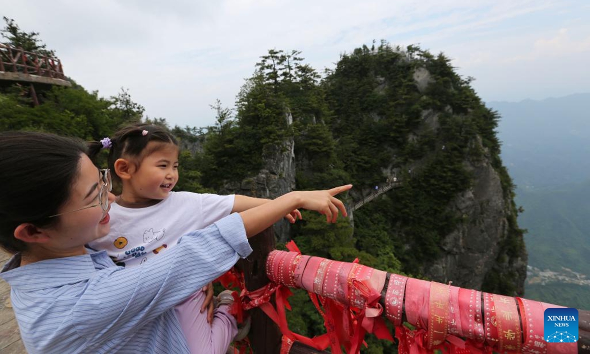 People visit the Qinling Tianzhu Mountain Eco-Cultural Scenic Area in Shangluo, northwest China's Shaanxi Province, June 16, 2026.
Nestled in the hinterland of the Qinling Mountains, Tianzhu Mountain boasts gorgeous natural scenery and high vegetation coverage, attracting many tourists. (Xinhua/Wang Ying)