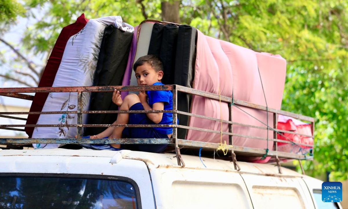 This photo taken on June 15, 2026 shows a displaced boy in preparation for returning to his village in Sidon, southern Lebanon. Despite their different experiences, displaced residents interviewed by Xinhua shared a common belief that returning home depends not only on ending the fighting but also on rebuilding damaged communities and restoring basic services. (Photo by Ali Hashisho/Xinhua)