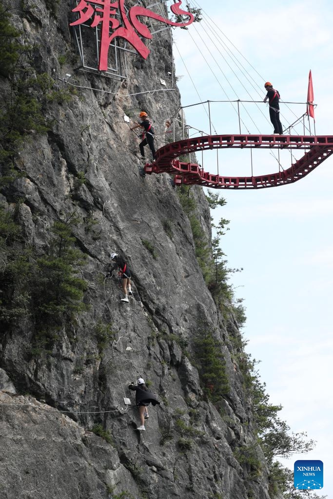 Tourists try rock climbing at the Qinling Tianzhu Mountain Eco-Cultural Scenic Area in Shangluo, northwest China's Shaanxi Province, June 16, 2026.
Nestled in the hinterland of the Qinling Mountains, Tianzhu Mountain boasts gorgeous natural scenery and high vegetation coverage, attracting many tourists. (Xinhua/Wang Ying)