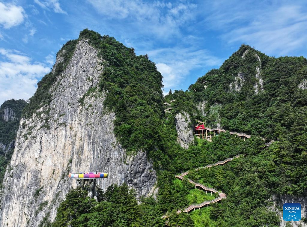 A drone photo taken on June 16, 2026 shows a view of the Qinling Tianzhu Mountain Eco-Cultural Scenic Area in Shangluo, northwest China's Shaanxi Province.
Nestled in the hinterland of the Qinling Mountains, Tianzhu Mountain boasts gorgeous natural scenery and high vegetation coverage, attracting many tourists. (Xinhua/Wang Ying)