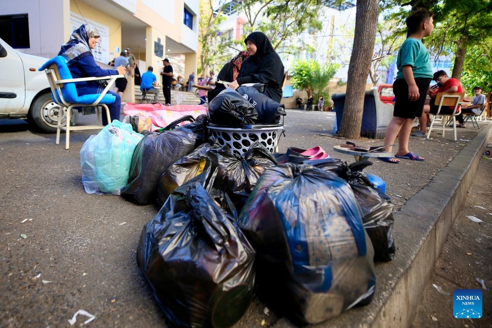 This photo taken on June 15, 2026 shows displaced people collecting their luggage in preparation for returning to their villages in Sidon, southern Lebanon. Despite their different experiences, displaced residents interviewed by Xinhua shared a common belief that returning home depends not only on ending the fighting but also on rebuilding damaged communities and restoring basic services. (Photo by Ali Hashisho/Xinhua)