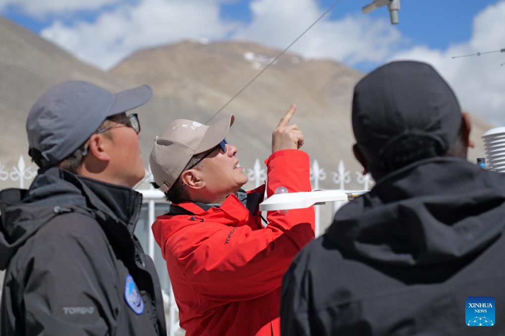 This photo taken on June 4, 2026 shows Ma Yaoming (2nd L), founder of the National Field Observation and Research Station (Xizang Dingri) for Qomolangma Special Atmospheric Processes and Environmental Change, checking devices with researchers in southwest China's Xizang Autonomous Region. (Xinhua/Zhou Yulong)