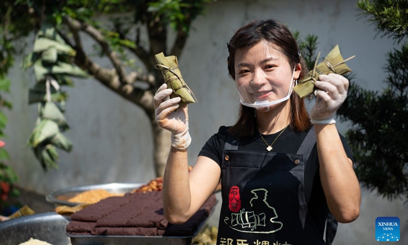 Zheng Hui, a young entrepreneur, shows zongzi she has made by hands at Shiren Village of Xiuning County, Huangshan City of east China's Anhui Province, June 15, 2026. Shiren Village, dubbed the hometown of zongzi (sticky rice dumplings) in ancient Huizhou, boasts a long tradition of zongzi making. The annual sales of zongzi in the village has reached 900,000 yuan (about 133,000 U.S. dollars). (Xinhua/Zhang Duan)