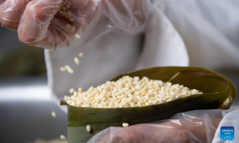 A villager makes zongzi at Shiren Village of Xiuning County, Huangshan City of east China's Anhui Province, June 13, 2026. Shiren Village, dubbed the hometown of zongzi (sticky rice dumplings) in ancient Huizhou, boasts a long tradition of zongzi making. The annual sales of zongzi in the village has reached 900,000 yuan (about 133,000 U.S. dollars). (Xinhua/Zhang Duan)