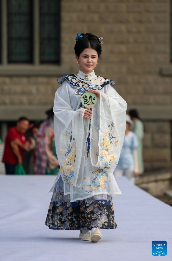 A foreign student presents traditional Chinese costumes during a fashion show at Tianjin Foreign Studies University in north China's Tianjin, June 17, 2026. A show focusing on traditional Chinese costumes was held here on Wednesday as part of this year's Tianjin Fashion Week. Models and foreign students trooped the runway to bridge China and rest parts of the world with wearable creations that inspire cultural exchange and mutual learning. (Xinhua/Sun Fanyue)