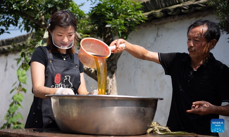 Zheng Hui (L), a young entrepreneur, prepares materials for zongzi making at Shiren Village of Xiuning County, Huangshan City of east China's Anhui Province, June 15, 2026. Shiren Village, dubbed the hometown of zongzi (sticky rice dumplings) in ancient Huizhou, boasts a long tradition of zongzi making. The annual sales of zongzi in the village has reached 900,000 yuan (about 133,000 U.S. dollars). (Xinhua/Zhang Duan)