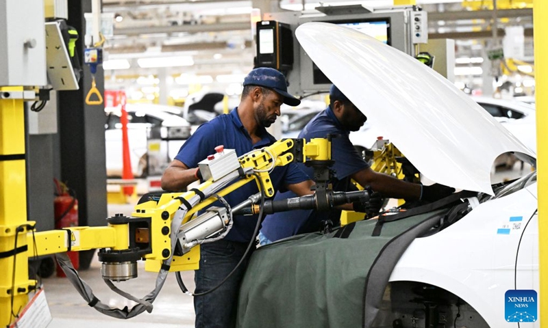 A worker (L) operates a mechanical arm to perform assembly work at the production base complex of BYD in Camacari, Bahia State, Brazil, June 12, 2026. About 50 kilometers away from Salvador, the capital of the northeastern Brazilian state of Bahia, the Camacari production base complex of Chinese auto manufacturer BYD has been put into operation since last year. (Xinhua/Jin Haoyuan)