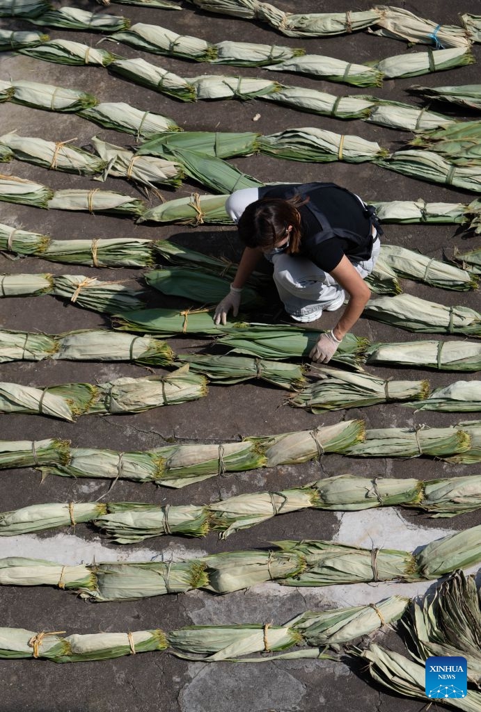 Zheng Hui, a young entrepreneur, dries bamboo leaves at Shiren Village of Xiuning County, Huangshan City of east China's Anhui Province, June 15, 2026. Shiren Village, dubbed the hometown of zongzi (sticky rice dumplings) in ancient Huizhou, boasts a long tradition of zongzi making. The annual sales of zongzi in the village has reached 900,000 yuan (about 133,000 U.S. dollars). (Xinhua/Zhang Duan)