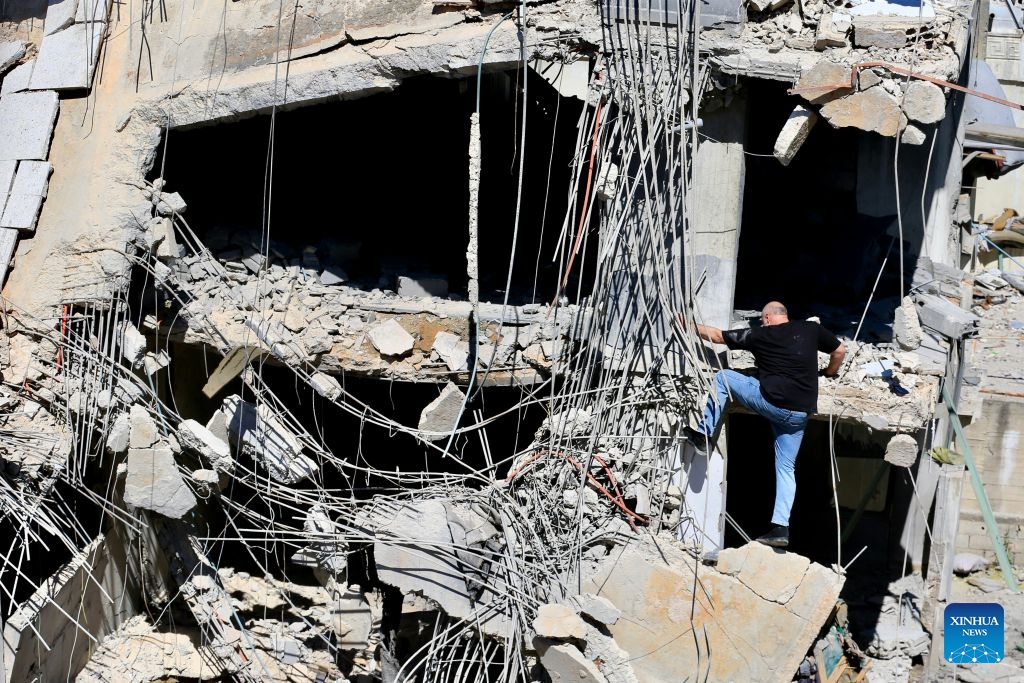 Photo taken on June 18, 2026 shows a man climbing a ruined building after Israeli attacks in Nabatieh, southern Lebanon. (Photo: Xinhua)
