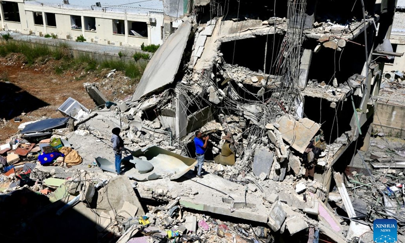 Photo taken on June 18, 2026 shows people inspecting their destroyed homes after Israeli attacks in Nabatieh, southern Lebanon. (Photo: Xinhua)