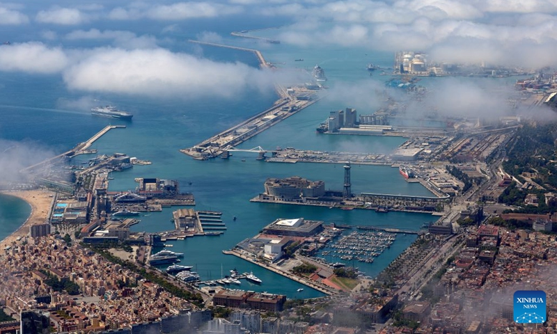 An aerial photo taken on June 18, 2026 shows the seascape of Barcelona, Spain. Barcelona displays its distinctive grid layout, with the Sagrada Familia Basilica rising prominently among the city blocks. Designed by urban planner Ildefons Cerda in the 19th century, the grid structure continues to shape the development and identity of the Mediterranean city. (Photo: Xinhua)