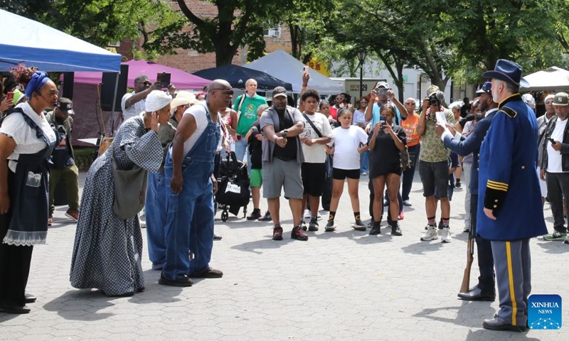 People reenact the announcement of emancipating the remaining enslaved people during a Juneteenth celebration in Staten Island, New York City, the United States, on June 19, 2026. Celebrated on June 19, Juneteenth marks the day in 1865 when Union Major General Gordon Granger issued General Order No. 3 in Galveston, Texas, emancipating the remaining enslaved people in the state. For enslaved Americans in Texas, freedom came two and a half years after President Abraham Lincoln issued the Emancipation Proclamation. (Xinhua/Zhang Fengguo)
