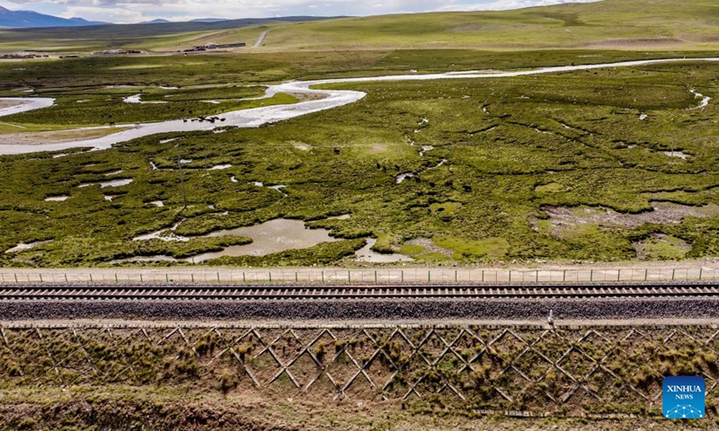 An aerial drone photo taken on June 18, 2026 shows a herd of yaks crossing a creek near the Qinghai-Xizang Railway in Seni District of Nagqu, southwest China's Xizang Autonomous Region. As the Qinghai-Xizang Railway stretches across the northern Tibetan Plateau, it has built not only dedicated wildlife crossings, but also many culverts and bridges to serve as ecological corridors for livestock such as cattle and sheep. (Xinhua/Yang Zhisen)