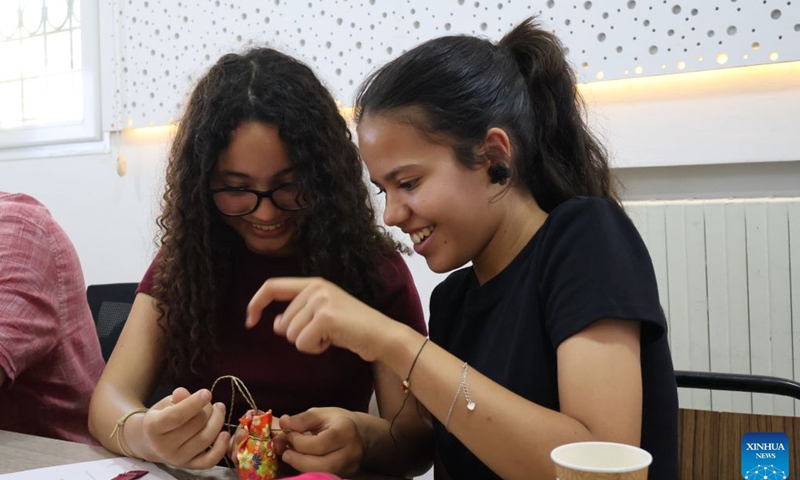 Students make sachets at the Confucius Institute at Carthage University in Tunis, Tunisia, on June 19, 2026. The Confucius Institute at the Carthage University held on Friday a Dragon Boat Festival cultural event, attracting many people to experience the unique charm of Chinese traditional culture. (Xinhua/Zhou Haojin)