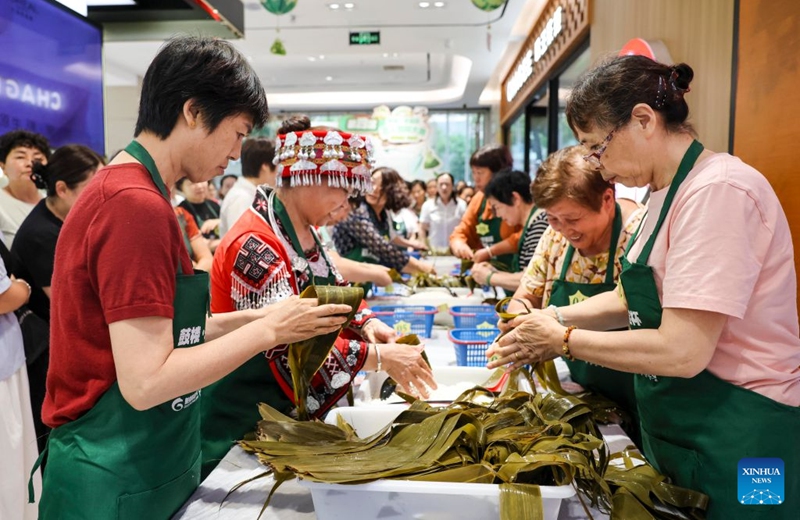 People attend a Zongzi making contest at a shopping center in Taixing, east China's Jiangsu Province, June 19, 2026. Friday marks the Duanwu Festival, or Dragon Boat Festival, a traditional festival celebrated on the 5th day of the 5th month in the traditional Chinese calendar.

The festival is best known for holding dragon boat race, eating Zongzi, sticky rice dumplings wrapped with bamboo or reed leaves, and hanging mugwort and calamus as symbol of health and protection. Photo: Xinhua