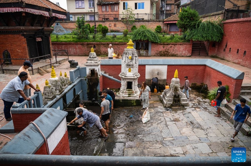 People clean stone water spouts on the occasion of the Sithi Nakha festival in Lalitpur, Nepal, on June 20, 2026. The Newar community celebrated the Sithi Nakha festival to mark the beginning of monsoon season by cleaning water sources such as ponds, wells and stone spouts. (Photo by Hari Maharjan/Xinhua)