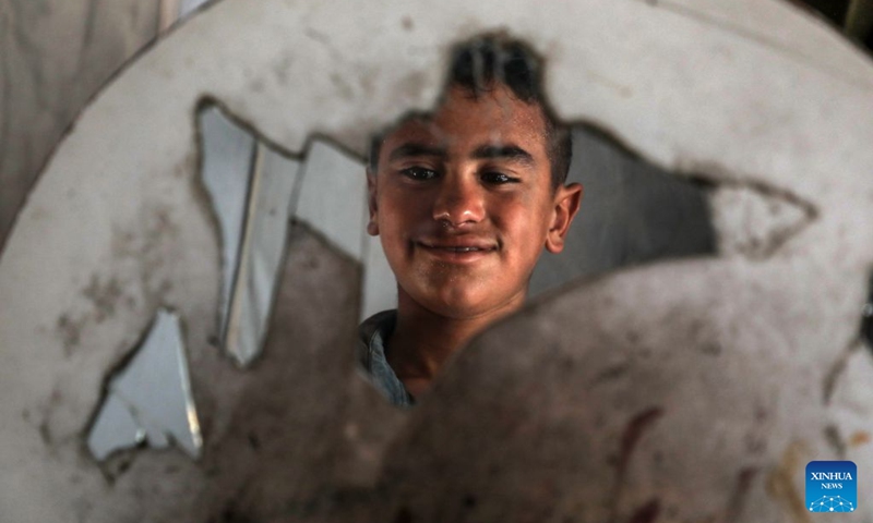 This photo taken on June 18, 2026 shows a boy at a camp for displaced people in Gaza City. Commemorated annually on June 20, World Refugee Day honors and celebrates the strength and bravery of refugees, individuals forced to flee their homelands due to conflicts, persecution or human rights violations.

In the Middle East, where wars, conflicts and instability continue, a large number of people have been forced to flee their homes and embark on the path of displacement. Photo: Xinhua