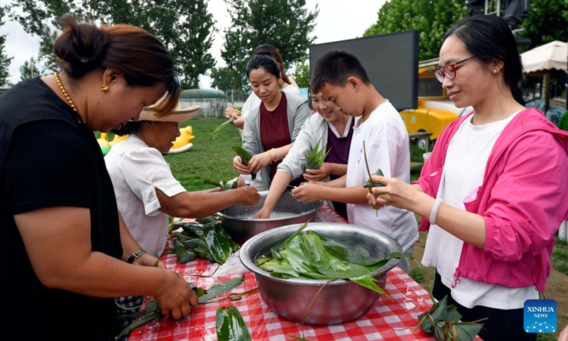 People attend a Zongzi making contest at a scenic spot in Zunhua, north China's Hebei Province, June 20, 2026. Friday marks the Duanwu Festival, or Dragon Boat Festival, a traditional festival celebrated on the 5th day of the 5th month in the traditional Chinese calendar.

The festival is best known for holding dragon boat race, eating Zongzi, sticky rice dumplings wrapped with bamboo or reed leaves, and hanging mugwort and calamus as symbol of health and protection. Photo: Xinhua