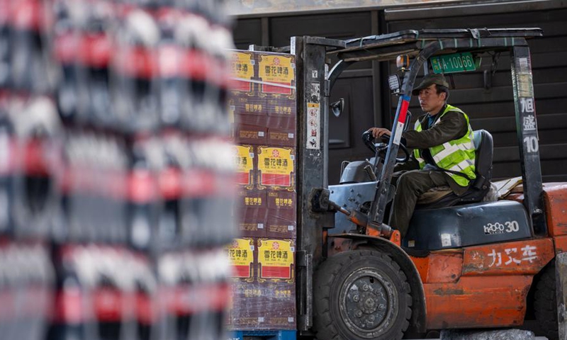 A staff member operates a forklift to unload goods at the freight yard of Lhasa West Railway Station in Lhasa, southwest China's Xizang Autonomous Region, on June 18, 2026. (Xinhua/Tenzing Nima Qadhup)