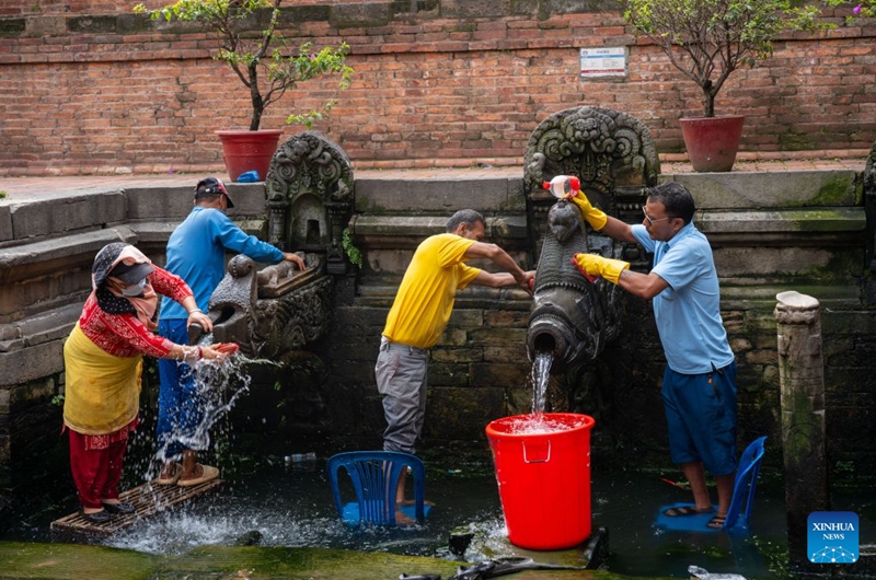 People clean stone water spouts on the occasion of the Sithi Nakha festival in Lalitpur, Nepal, on June 20, 2026. The Newar community celebrated the Sithi Nakha festival to mark the beginning of monsoon season by cleaning water sources such as ponds, wells and stone spouts. (Photo by Hari Maharjan/Xinhua)
