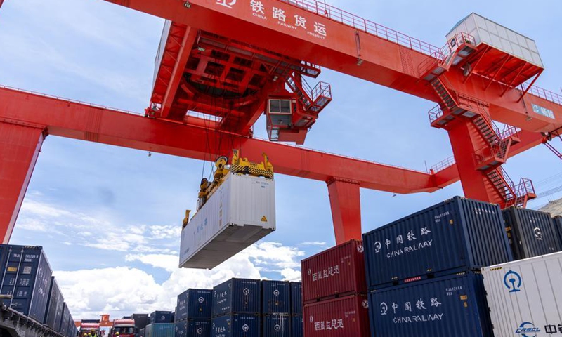 A gantry crane carries a container at the freight yard of Lhasa West Railway Station in Lhasa, southwest China's Xizang Autonomous Region, on June 18, 2026. (Xinhua/Tenzing Nima Qadhup)