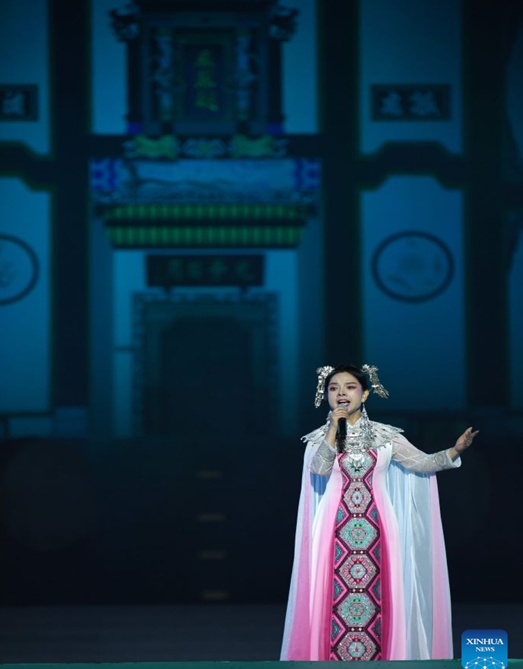 An actress performs during a poetry gathering to celebrate the Dragon Boat Festival in front of the memorial temple of Qu Yuan, a renowned patriotic poet and minister of the State of Chu during the Warring States Period (475-221 BC), in Zigui County, central China's Hubei Province, June 19, 2026. (Xinhua/Ma Ning)