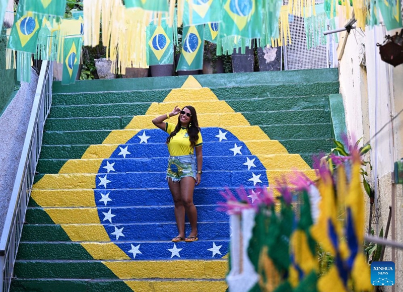 A Brazilian football fan poses for photos at a street decorated with elements of World Cup in Rio de Janeiro, Brazil, June 19, 2026. (Xinhua/Jin Haoyuan)