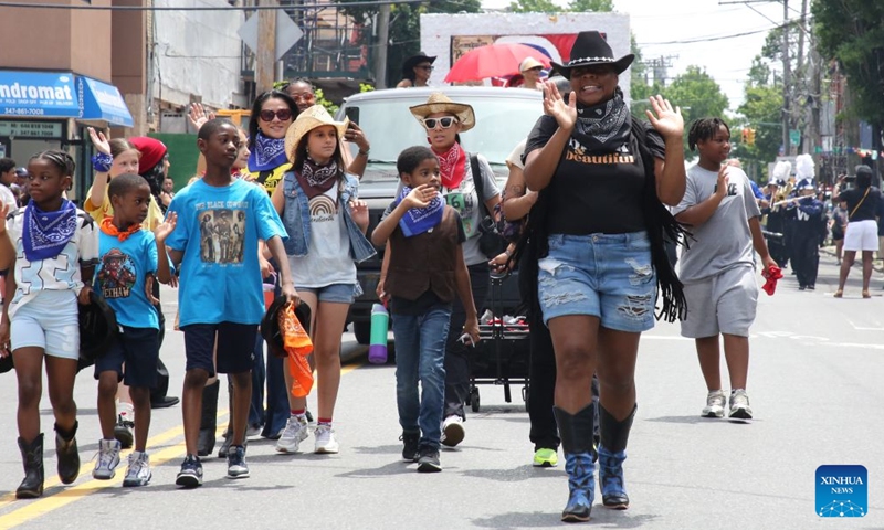 People attend a Juneteenth parade in Staten Island, New York City, the United States, on June 19, 2026. Celebrated on June 19, Juneteenth marks the day in 1865 when Union Major General Gordon Granger issued General Order No. 3 in Galveston, Texas, emancipating the remaining enslaved people in the state. For enslaved Americans in Texas, freedom came two and a half years after President Abraham Lincoln issued the Emancipation Proclamation. (Xinhua/Zhang Fengguo)