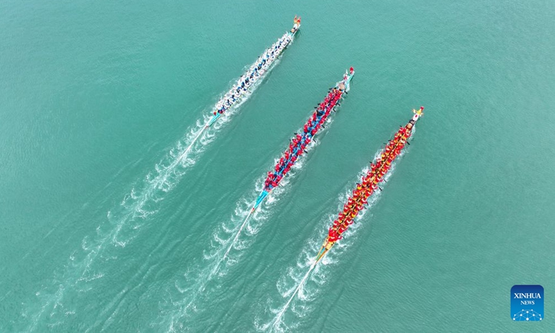 An aerial drone photo taken on June 18, 2026 shows people competing in a dragon boat race in the sea areas of Tailu Town of Lianjiang County, Fuzhou of southeast China's Fujian Province. The Dragon Boat Festival, also known as Duanwu Festival, is a traditional Chinese holiday to commemorate ancient Chinese poet Qu Yuan from the Warring States Period (475-221 B.C.). Celebrated on the fifth day of the fifth month of the Chinese lunar calendar, the festival falls on June 19 this year. (Xinhua/Zhou Yi)