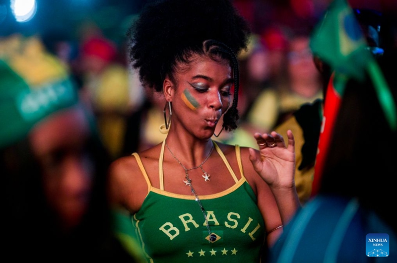 A Brazilian football fan dances while watching the live broadcast of the group C match between Brazil and Haiti at the 2026 FIFA World Cup at the Copacabana Beach in Rio de Janeiro, Brazil, on June 19, 2026. (Photo by Daniel Ramalho/Xinhua)