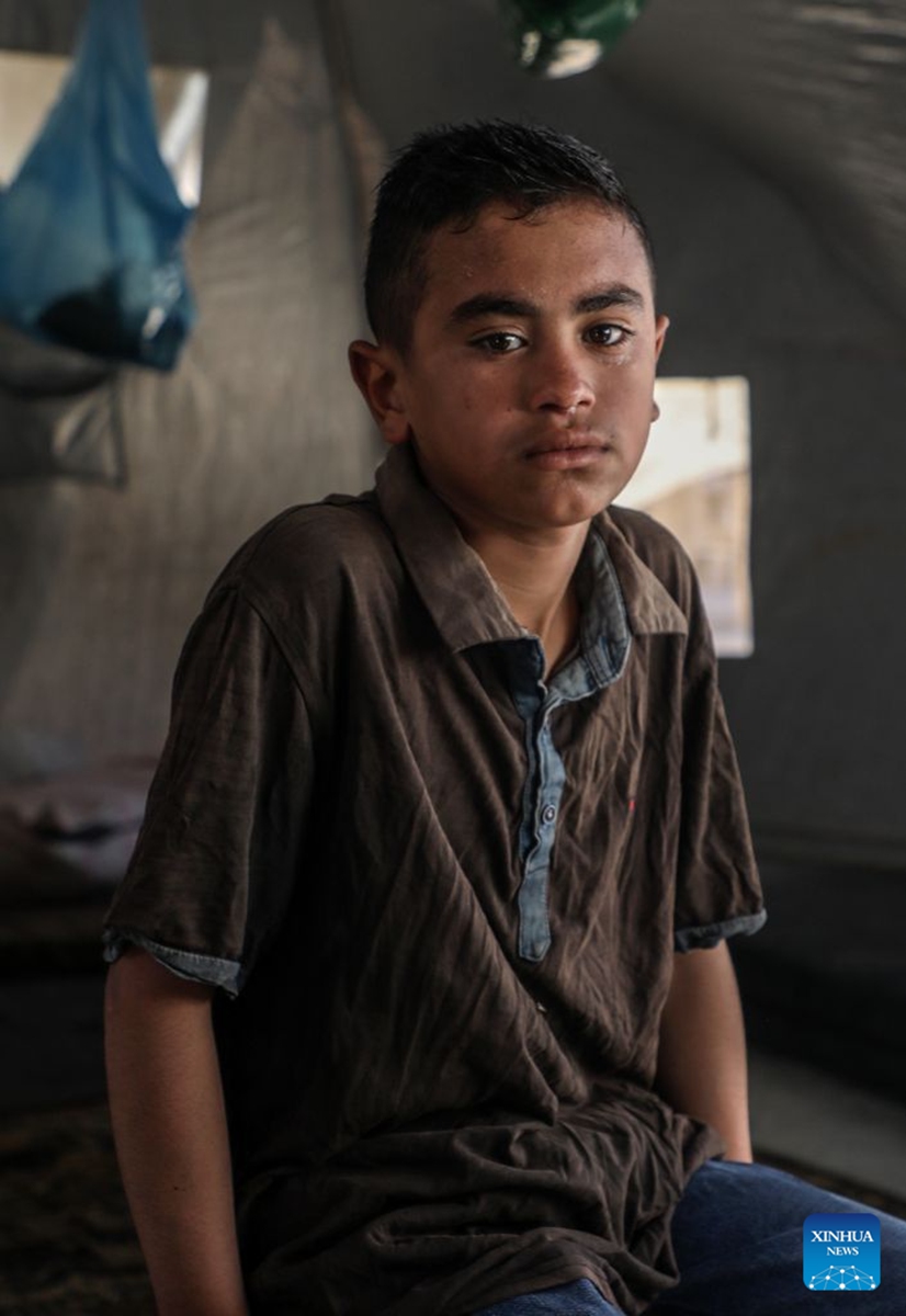This photo taken on June 18, 2026 shows a boy at a camp for displaced people in Gaza City. Commemorated annually on June 20, World Refugee Day honors and celebrates the strength and bravery of refugees, individuals forced to flee their homelands due to conflicts, persecution or human rights violations.

In the Middle East, where wars, conflicts and instability continue, a large number of people have been forced to flee their homes and embark on the path of displacement. Photo: Xinhua