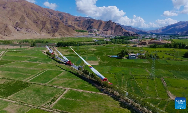 Wind turbine blades are transported in Shannan, southwest China's Xizang Autonomous Region, June 5, 2026. The first wind turbine of the Phase I of a wind power project built by the Xizang branch of China Huadian Corporation in Qonggyai County was completed on Thursday. The Phase I of this project will install 24 units of 6.25 MW wind turbines distributed between 4800 meters and 5350 meters altitude. (Xinhua)