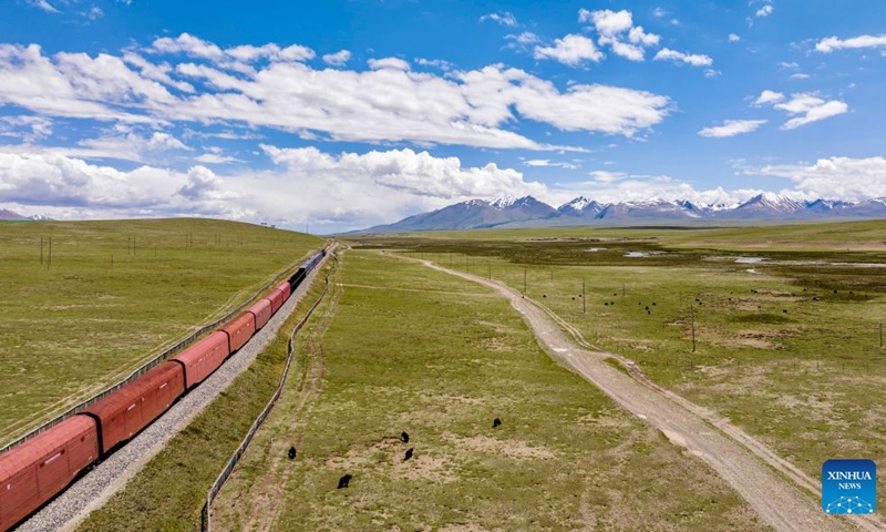 An aerial drone photo taken on June 18, 2026 shows yaks grazing near the Qinghai-Xizang Railway in Seni District of Nagqu, southwest China's Xizang Autonomous Region. As the Qinghai-Xizang Railway stretches across the northern Tibetan Plateau, it has built not only dedicated wildlife crossings, but also many culverts and bridges to serve as ecological corridors for livestock such as cattle and sheep. (Xinhua/Yang Zhisen)