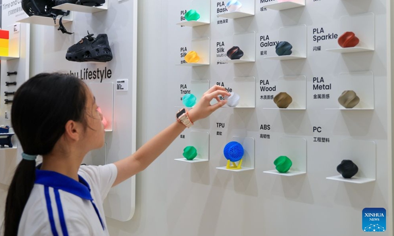 A student looks at the different materials available for consumer 3D printers at a flagship store in Shenzhen, south China's Guangdong Province, June 3, 2026. In recent years, consumer 3D printers have transformed from laboratory niche black technology to popular consumer products, covering different fields from home DIY and campus education to entrepreneurial innovation and large-scale production. (Xinhua/Mao Siqian)

