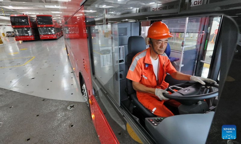 A staff member guides a driver to park a homemade electric double-decker bus on the vehicle deck of a car carrier at Yantai Port in Yantai, east China's Shandong Province, on July 5, 2026.
A total of twenty-two BYD electric double-decker buses on Sunday were shipped from Yantai Port to the United Kingdom. The buses will subsequently be put into service in London's public transport system. (Photo by Tang Ke/Xinhua)