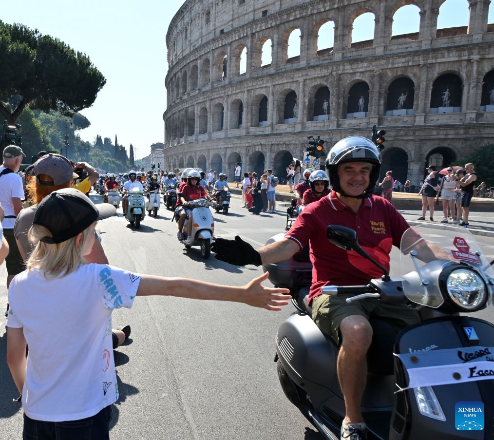 Vespa enthusiasts parade around the Colosseum during a celebration marking the 80th anniversary of the iconic Italian brand of scooters, in Rome, Italy, on June 27, 2026. (Photo by Alberto Lingria/Xinhua)

