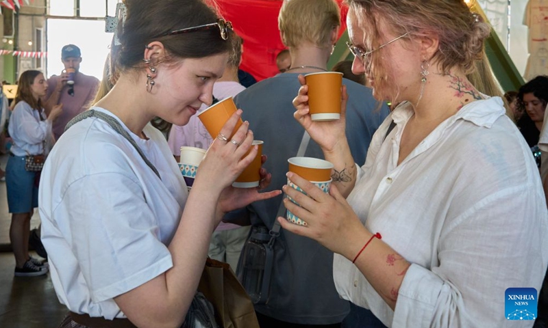 This photo taken on June 20, 2026 shows a scene of the Open Coffee Fest in St. Petersburg, Russia. The fest is held here from June 20 to 21. Baristas from all over Russia demonstrate their skills, attracting many citizens to taste coffee. (Photo by Guo Feizhou/Xinhua)

