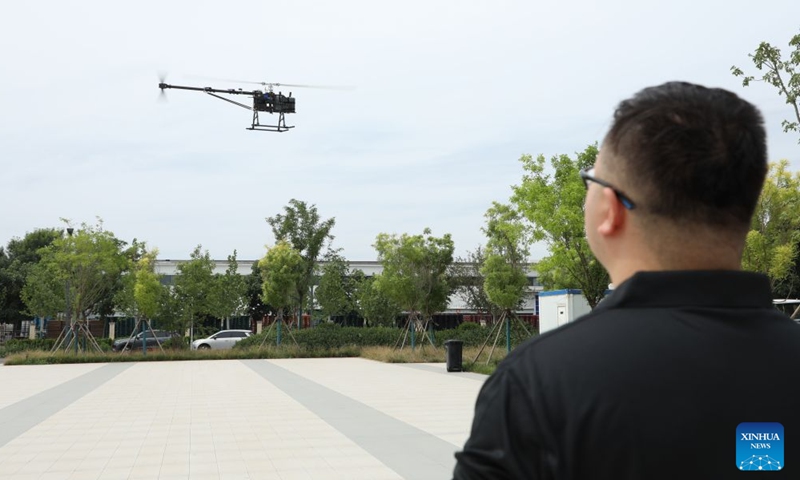 An employee adjusts a drone at a company inside the Handan Science and Technology Innovation Industrial Park in Handan, north China's Hebei Province, on June 26, 2026.