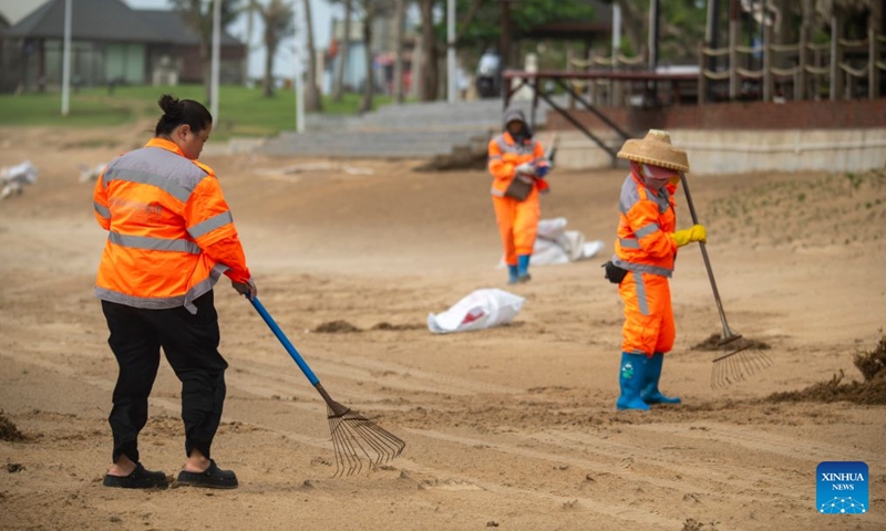 Sanitation workers collect debris and garbage washed ashore during a tropical storm landfall on a beach in Boao of Qionghai City, south China's Hainan Province, July 4, 2026. The tropical storm came ashore at around 6:20 p.m. in Yelin Township of Lingshui Li Autonomous County, according to the Hainan provincial meteorological bureau. At landfall, it packed maximum winds of 23 meters per second near its center. (Photo by Meng Zhongde/Xinhua)