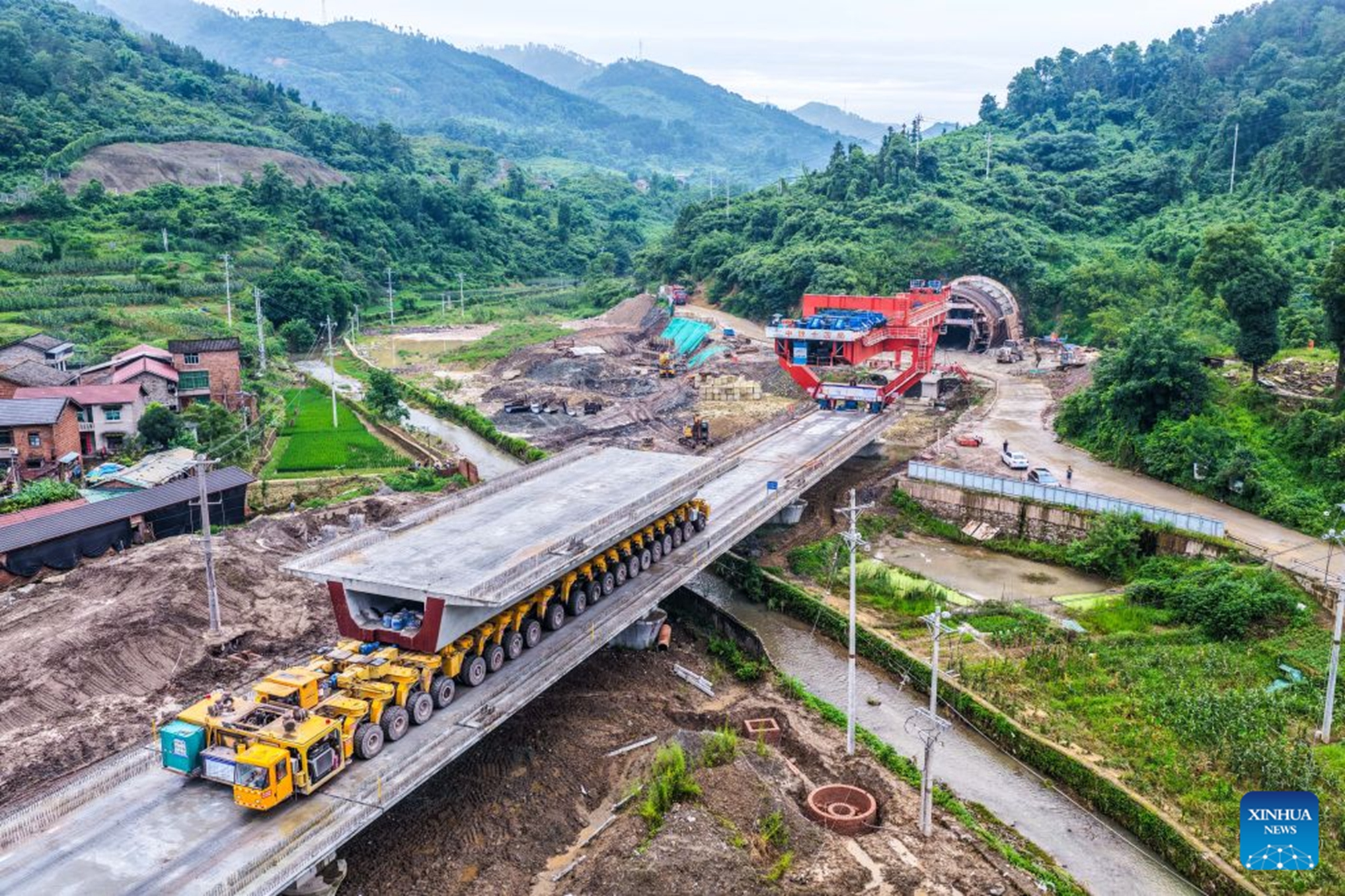 An aerial drone photo taken on June 28, 2026 shows the construction site of the Hechuan East Station grand bridge along the Xi'an-Chongqing High-speed Railway in southwest China's Chongqing Municipality. A 32-meter-long, approximately 700-tonne box girder was installed on the Hechuan East Station grand bridge on Monday, marking the completion of the box girder erection work on the Chongqing section of the Xi'an-Chongqing High-speed Railway. (Xinhua/Tang Yi)

