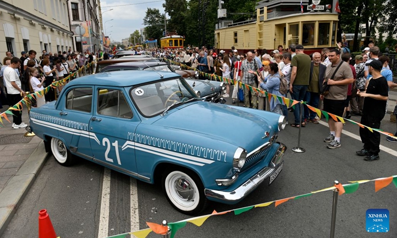 People view retro cars during a vintage vehicle exhibition in Moscow, Russia, July 11, 2026. A retro tram parade and a vintage vehicle exhibition were held on Saturday to celebrate the Moscow Transport Day, which falls on the second Saturday of July each year. (Photo by Alexander Zemlianichenko Jr/Xinhua)