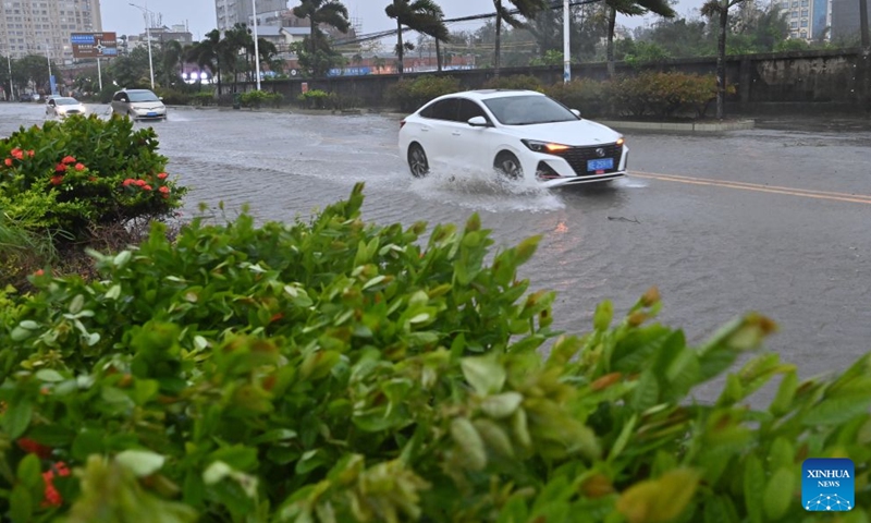 Vehicles drive amid wind and rain in Jiangping Town, Dongxing of Fangchenggang, south China's Guangxi Zhuang Autonomous Region, July 4, 2026. Typhoon Maysak, the 10th typhoon of the year, made a second landfall on Saturday night along the coast near the border between Guangxi and northern Vietnam. (Xinhua/Lu Boan)