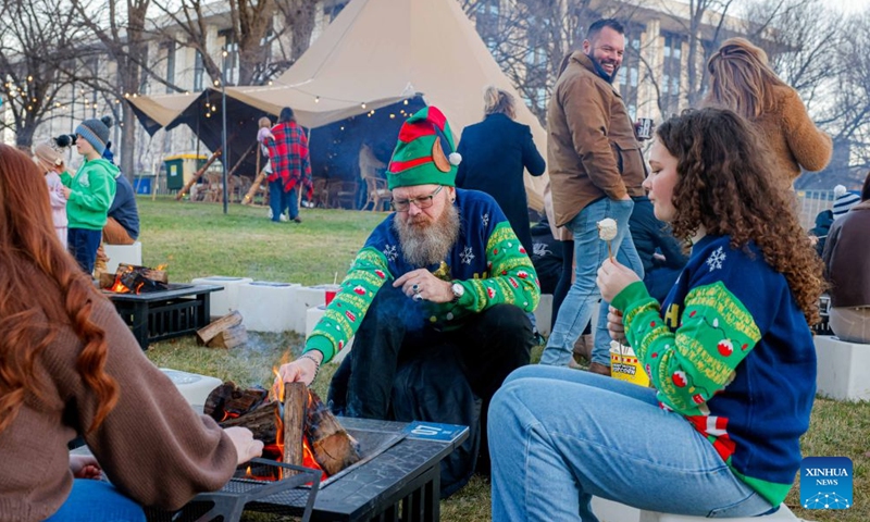 People enjoy themselves during the July Christmas event in Canberra, Australia, July 4, 2026. July Christmas stems from Australians' longing for a traditional white Christmas in the Southern Hemisphere. (Photo by Chu Chen/Xinhua)