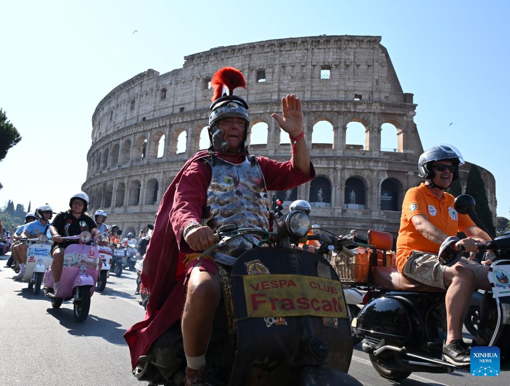 Vespa enthusiasts parade around the Colosseum during a celebration marking the 80th anniversary of the iconic Italian brand of scooters, in Rome, Italy, on June 27, 2026. (Photo by Alberto Lingria/Xinhua)

