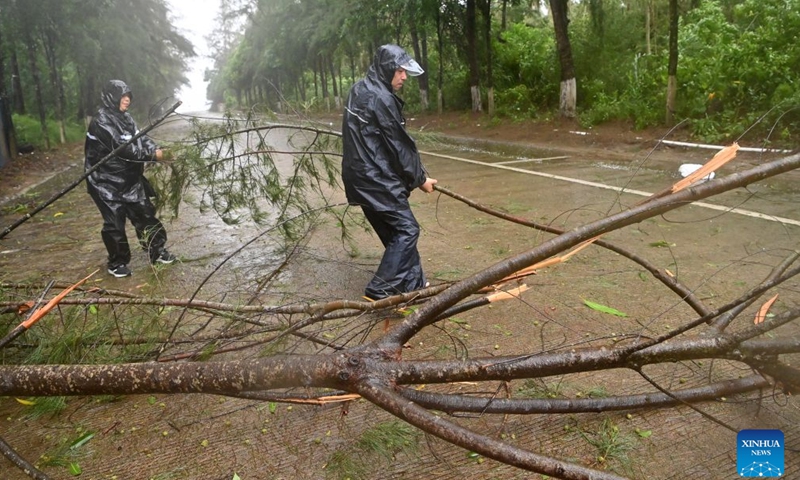 Staff members clear up a fallen tree in Jiangping Town, Dongxing of Fangchenggang, south China's Guangxi Zhuang Autonomous Region, July 4, 2026. Typhoon Maysak, the 10th typhoon of the year, made a second landfall on Saturday night along the coast near the border between Guangxi and northern Vietnam. (Xinhua/Lu Boan)
