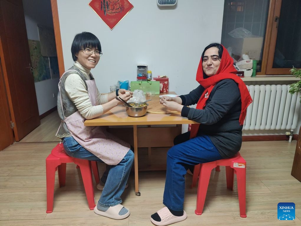 Asma Bibi (R), a Pakistani researcher at Tianjin University, makes dumplings at her supervisor's home during the Chinese Spring Festival in north China's Tianjin, Feb. 16, 2026. (Xinhua)

